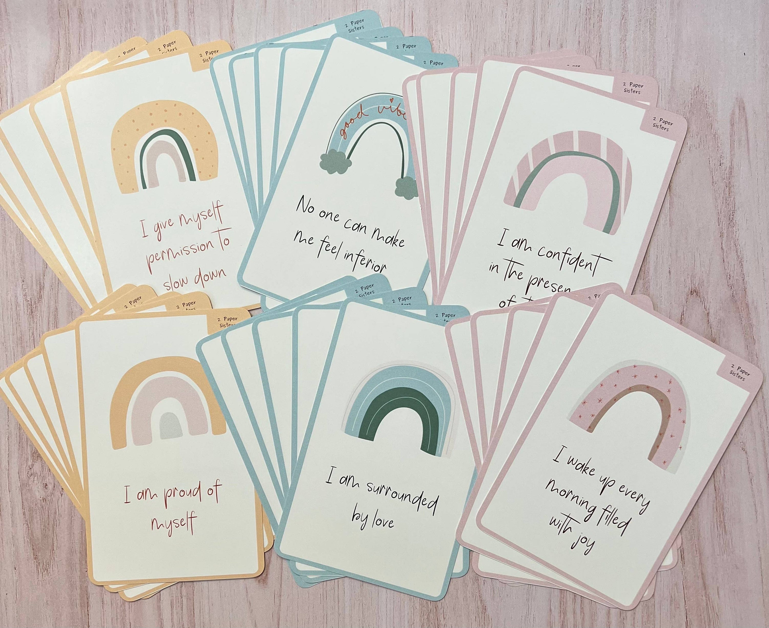 A display of all 30 Positive Affirmation Cards in yellow, blue, and pink.