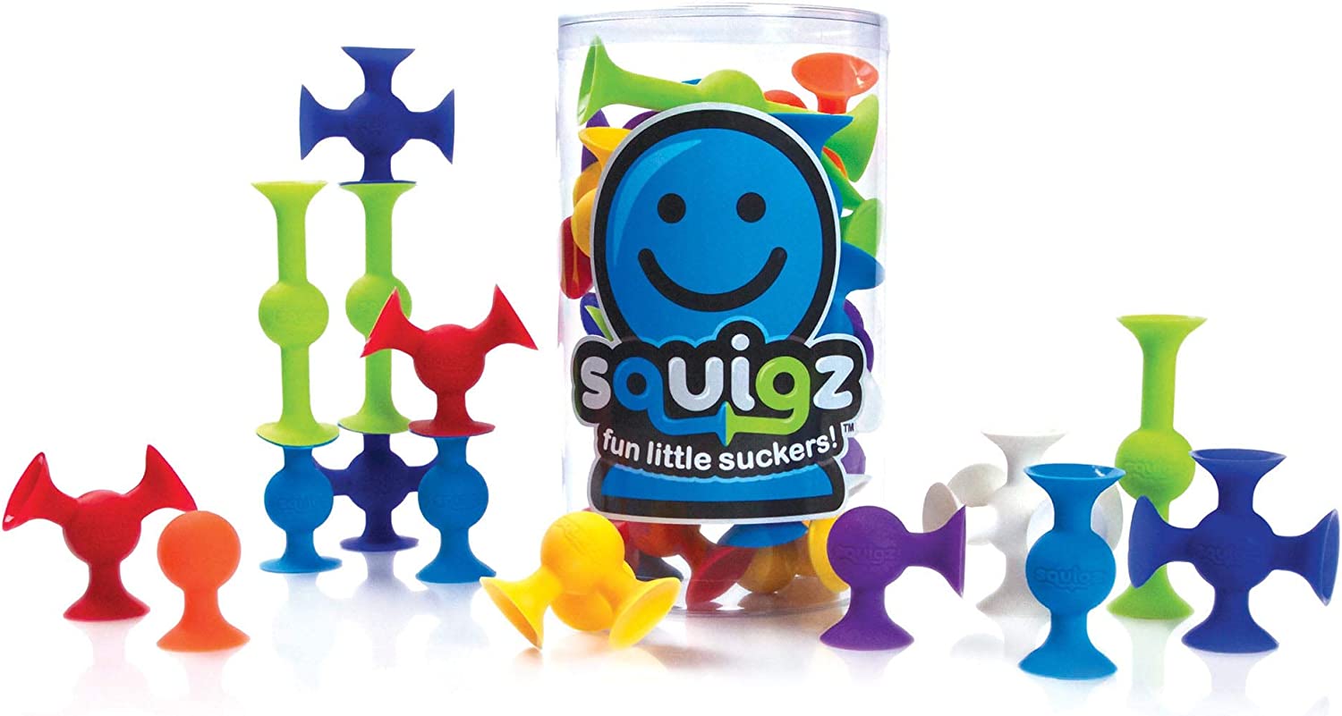 The product box for the Regular Squigz sits full. Many connected Squigz sit on either side of the box.