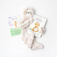Slumberkins Hazel Sloth Snuggler is pictured between the accompanying board book and affirmation card.