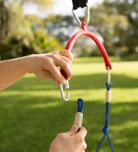 Two hands with light skin tone attach a part of the Swing to hardware.