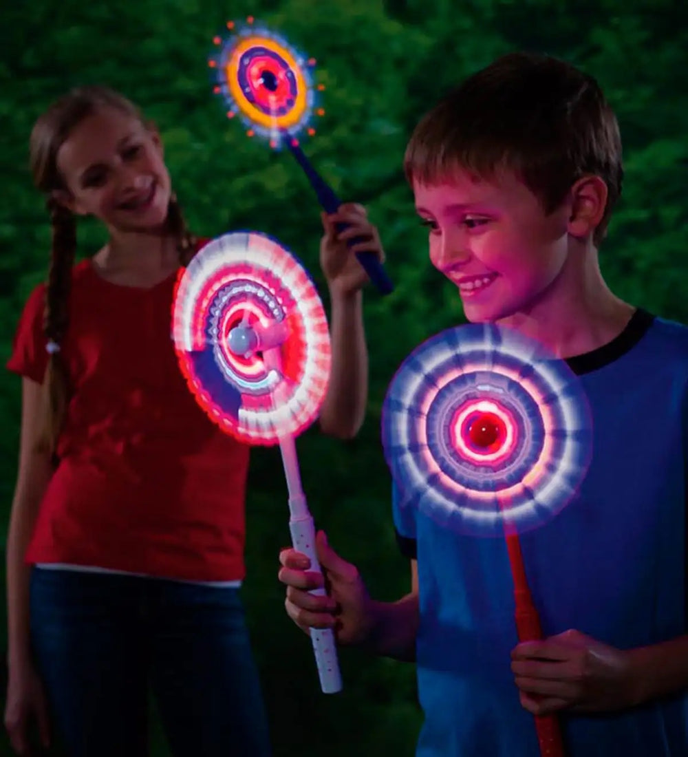 Two children holding up three Light Up Wands.