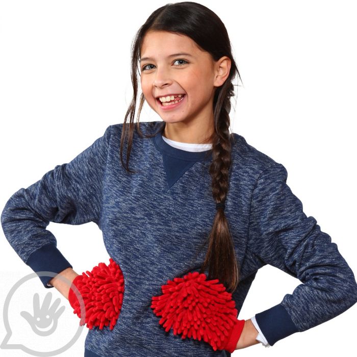 A child with light skin tone and a long dark brown braid stands with their hands on their hips. They are wearing the red anemone sensory mittens and smiling, revealing a missing tooth.