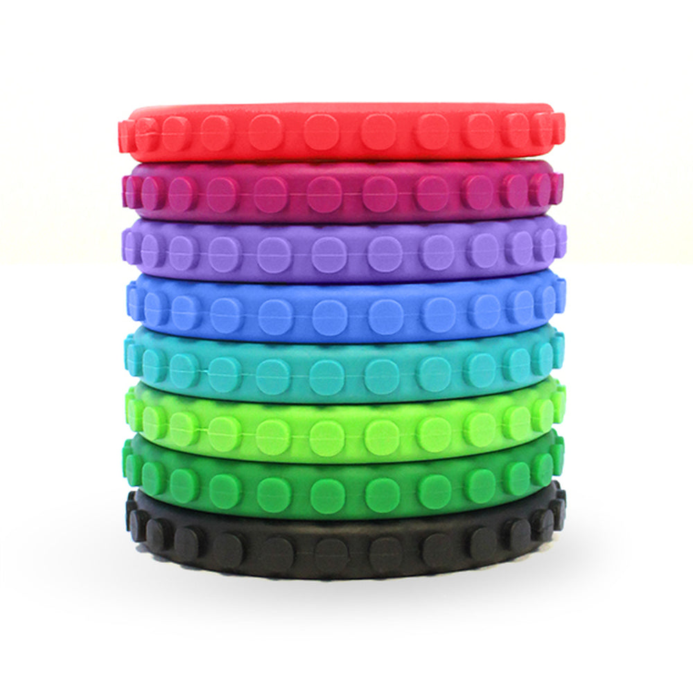 A stack of multicolored Textured Chewable Brick Bracelets.