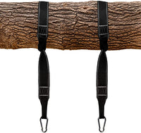 Two black nylon straps hang from a tree branch. Each has a carabiner attached at the bottom.