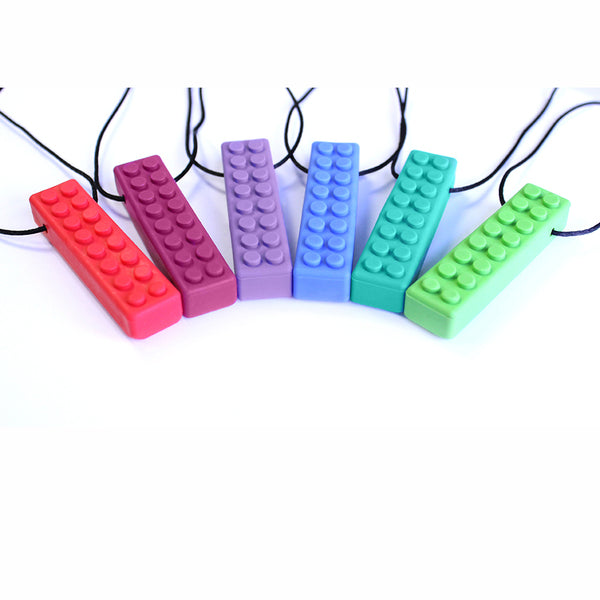 A rainbow display of Brick Stick Chew Necklaces.