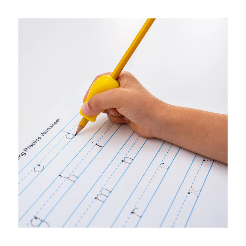 A child's hand with light skin tone holds a yellow Pencil Grips Jumbo on a pencil while tracing letters on a practice sheet.