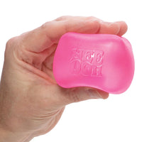 A hand with light skin tone holds the pink Nice Cube.