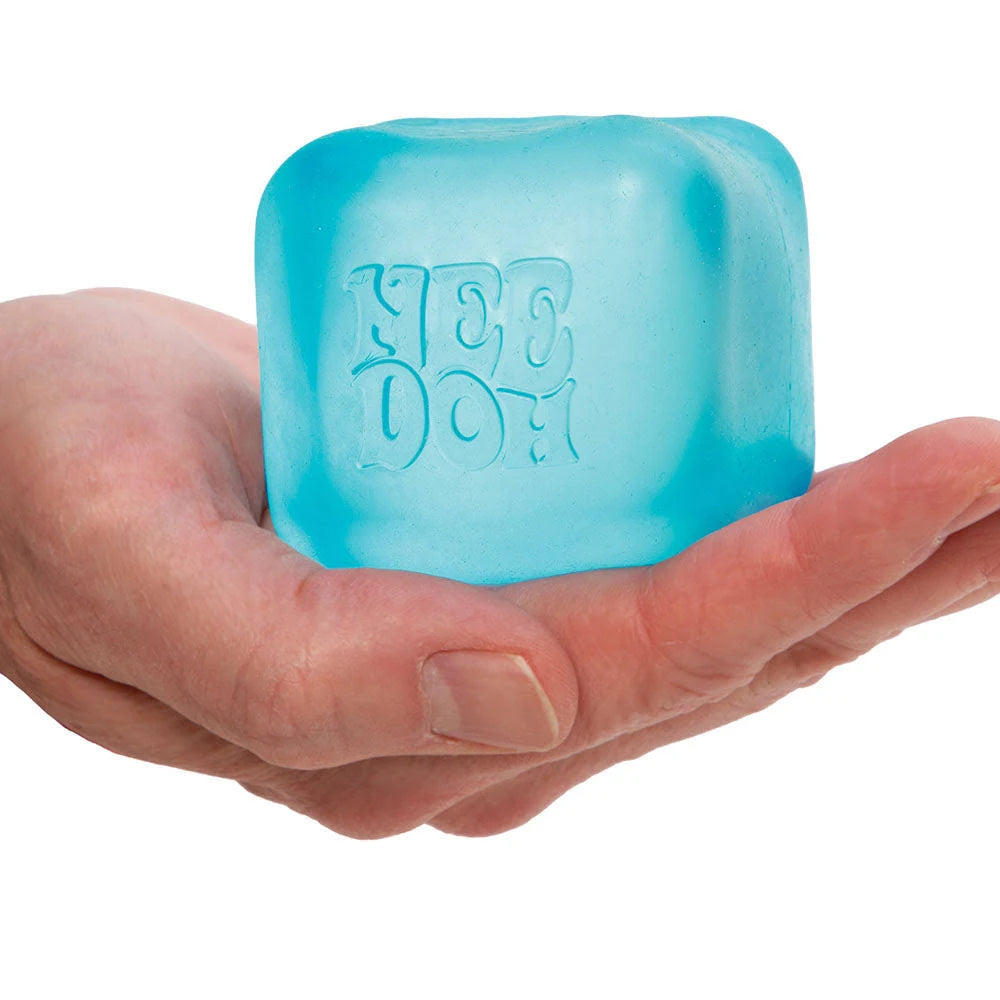 A hand with light skin tone holds a blue Nice Cube.