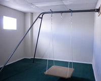 The Swing-Swing Wall Swing Stand with a carpeted platform swing attached to it.