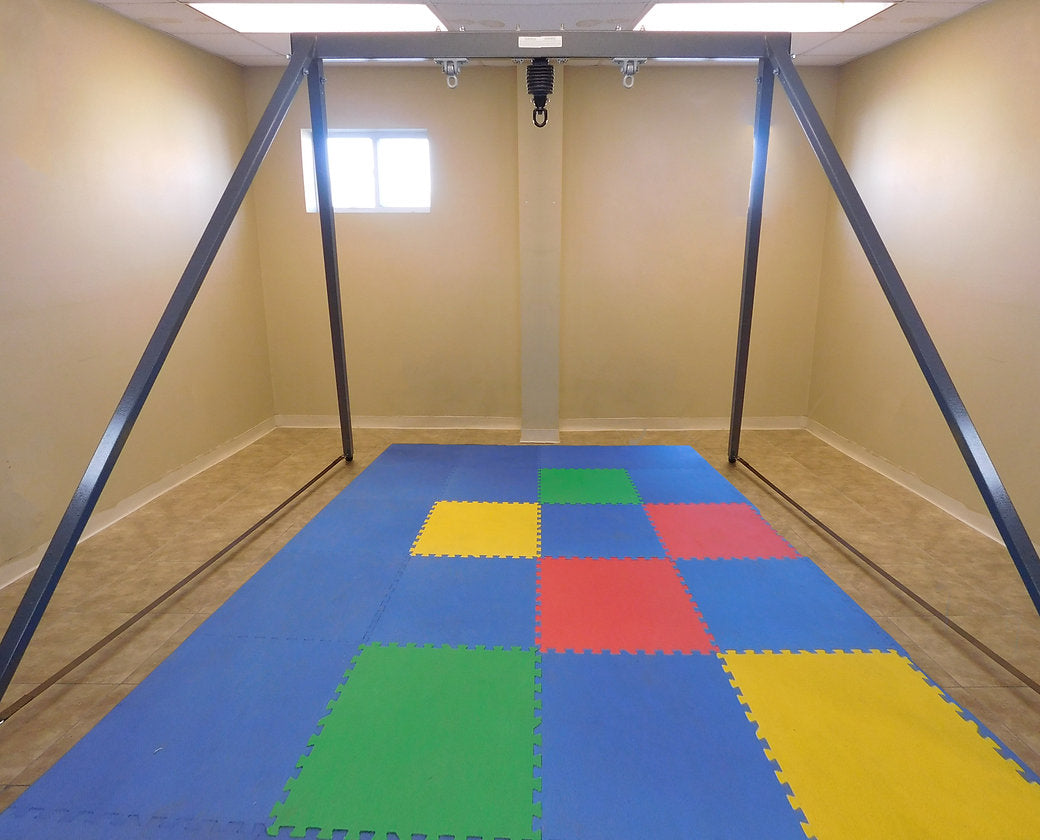 A Very Large Frame in a room above foam floor tiles.